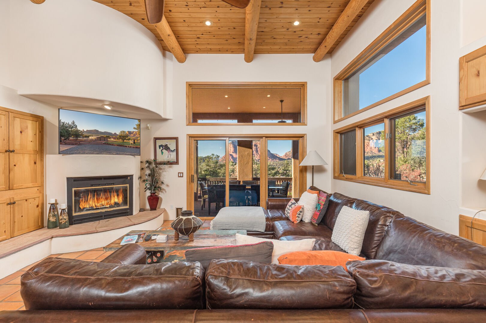 living room with leather couch and high ceilings