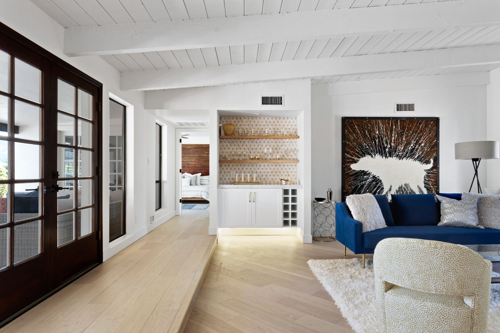 living area with view into bedroom