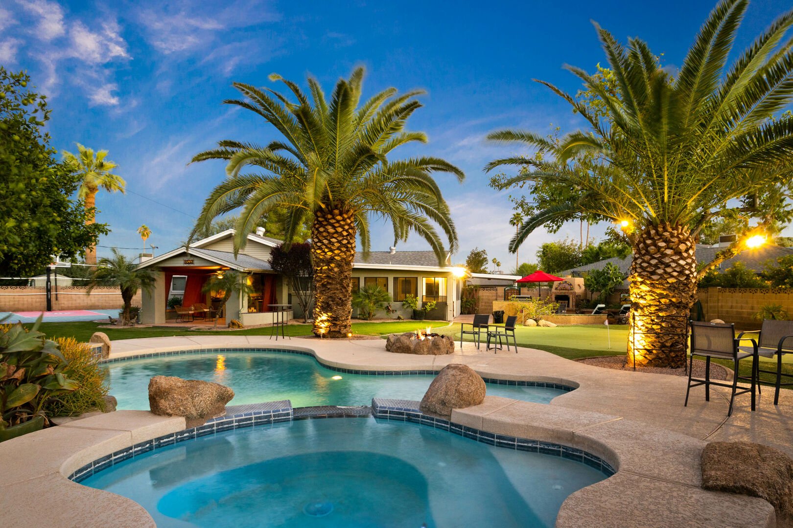 backyard with pool and palm trees