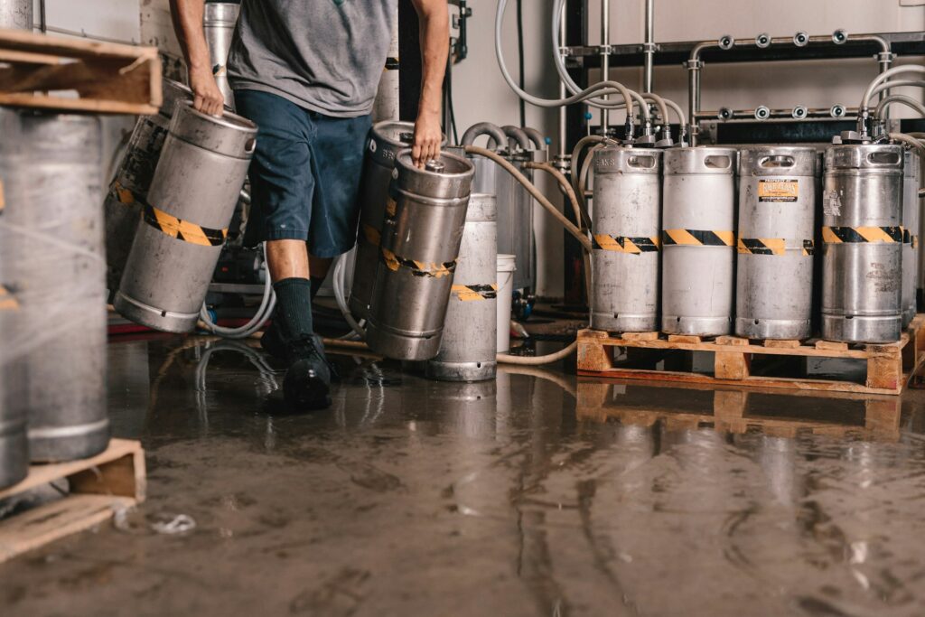 Person carrying beer kegs